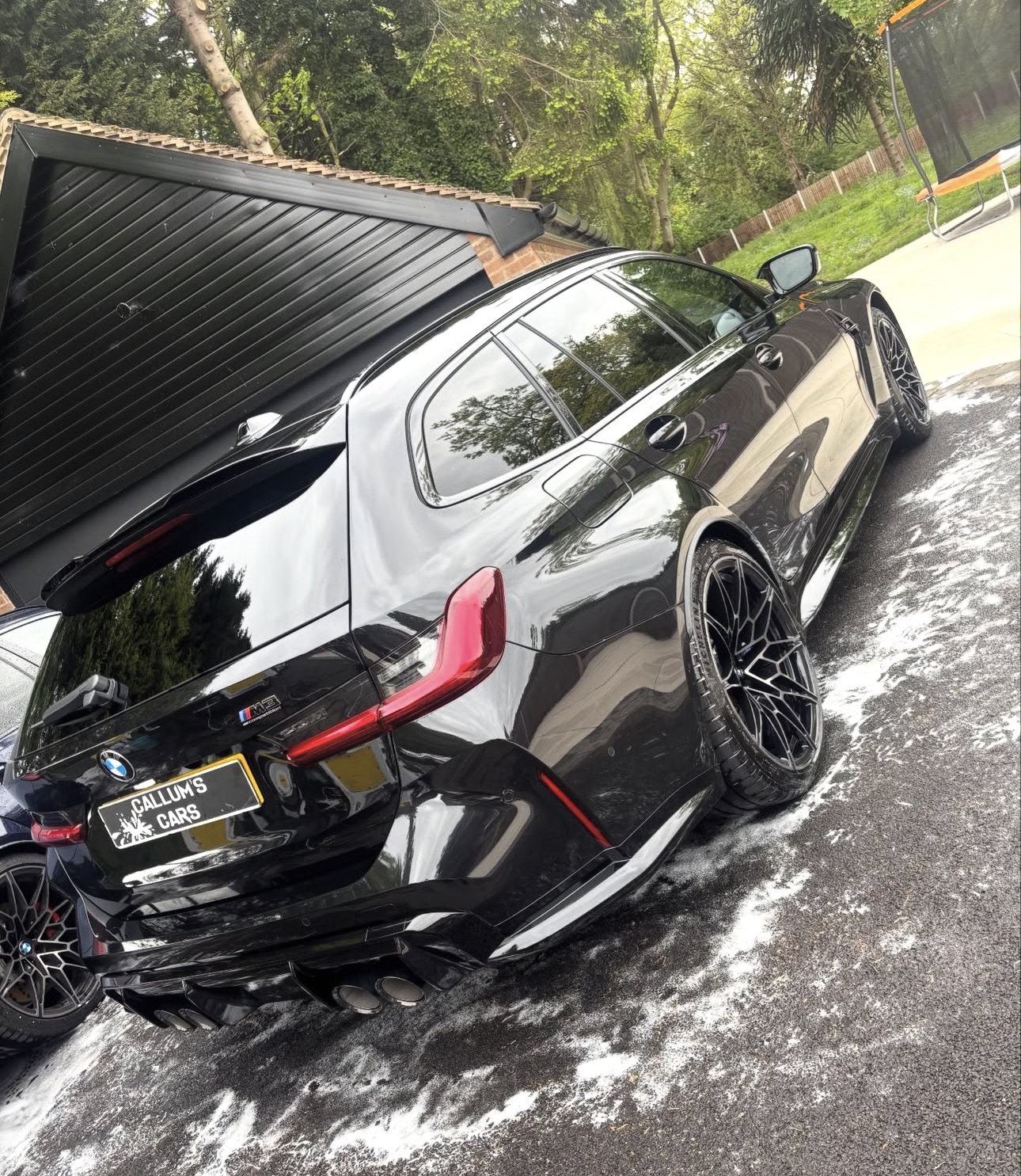 Black BMW M3 Touring with a Callum's Cars plate, freshly valeted
